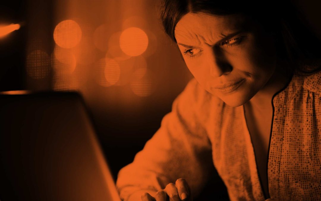 Woman looking untrustingly at a website on your laptop.